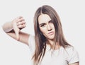 Young woman showing a thumb down, do not like it, portrait, life style and people concept Royalty Free Stock Photo