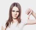 Young woman showing a thumb down, do not like it, portrait, life style and people concept Royalty Free Stock Photo