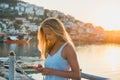 Young blond woman texting message at sunset, Alanya, Turkey