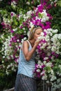 Young blond woman tourist smelling flowers in the old town center of Alanya Royalty Free Stock Photo