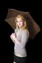 Young blond woman with umbrella on black Royalty Free Stock Photo