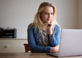 Young blond woman using laptop at home Royalty Free Stock Photo