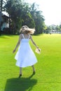 Young blond woman walking on a green loan on a sunny day Royalty Free Stock Photo