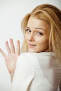 Young blond woman on white backgroung gesture thumbs up, isolated emotional posing close up, lifestyle people concept