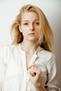 Young blond woman on white backgroung gesture thumbs up, isolated emotional posing close up, lifestyle people concept