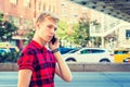 Young blonde American Man talking on cell phone outside in New York City Royalty Free Stock Photo