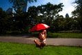 Young Blonde Athletic woman holding a Red Umbrella