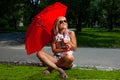 Young Blonde Athletic woman holding a Red Umbrella