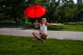 Young Blonde Athletic woman holding a Red Umbrella