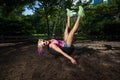 Young Blonde Athletic woman sitting on a tire swing