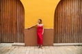 Young, blonde, beautiful woman in a red dress is visiting seville. The woman is posing for the camera very elegant for the photos Royalty Free Stock Photo