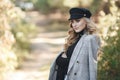 Young blonde beautiful woman spends time alone on a sunny day in a city park Royalty Free Stock Photo