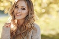 Young blonde beautiful woman spends time alone on a sunny day in a city park Royalty Free Stock Photo