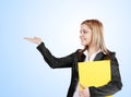 Young blonde business woman holding yellow file.