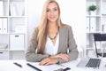 Young blonde business woman with laptop in the office Royalty Free Stock Photo