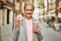 Young blonde businesswoman having breakfast at the city Royalty Free Stock Photo