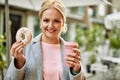 Young blonde businesswoman having breakfast at the city Royalty Free Stock Photo