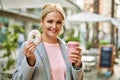 Young blonde businesswoman having breakfast at the city Royalty Free Stock Photo