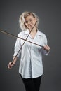 Young blonde caucasian girl violinist posing holding two violin bows