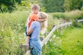 Young blonde Caucasian mother and boy toddler son hugging kissing in park outdoor on summer day. Royalty Free Stock Photo