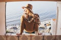 Young blonde Caucasian woman relaxing in her campervan at sunset