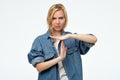 Young blonde caucasian woman showing time out sign over white background. Royalty Free Stock Photo