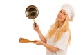 Young blonde chef woamn holds kitchenware as she prepares to coo