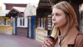 Young blonde with a cup of coffee. Woman at the food court Royalty Free Stock Photo