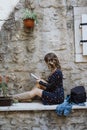 Young blonde curly haired beautiful woman reading an e-book in o Royalty Free Stock Photo