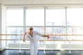 Young blonde dancer enjoys winning in white suit and makes warm Royalty Free Stock Photo