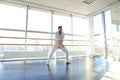 Young blonde dancer enjoys winning in white suit and makes warm Royalty Free Stock Photo