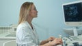 Young blonde female doctor viewing an ultrasound result