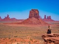 Young blonde girl admires panorama from Artist`s Point in Oljato Monument Valley Royalty Free Stock Photo