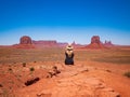 Young blonde girl admires panorama from Artist`s Point in Oljato Monument Valley Royalty Free Stock Photo