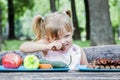 Young blonde girl choosing food for her meal Royalty Free Stock Photo