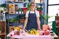 Young blonde girl florist smiling confident standing at florist