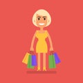 Young blonde girl holding shopping bags and smiling Royalty Free Stock Photo