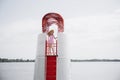 Young blonde girl look like a Barbie doll in pink mini dress and wide brim hat standing on lifeguard beach tower Royalty Free Stock Photo