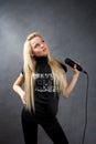 young blonde girl with microphone Royalty Free Stock Photo