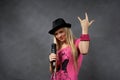 Young blonde girl with microphone Royalty Free Stock Photo