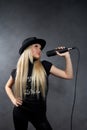 Young blonde girl with microphone Royalty Free Stock Photo