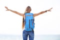 Young blonde girl with raised arms at sea shore Royalty Free Stock Photo