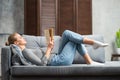 Young blonde girl is reading a book or a textbook. A beautiful woman is resting and relaxing at home. Royalty Free Stock Photo