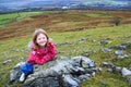 Girl Resting on Rocks During Hill Walk Royalty Free Stock Photo