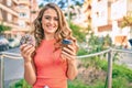 Young blonde girl smiling happy having breakfast at the city