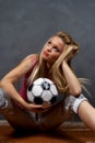 Young blonde girl with soccer ball Royalty Free Stock Photo