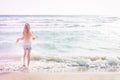 Young blonde girl standing on the beach Royalty Free Stock Photo