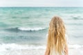 Young blonde girl standing on the beach Royalty Free Stock Photo