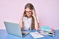 Young blonde girl wearing operator headset at the call center office with hand on head, headache because stress Royalty Free Stock Photo