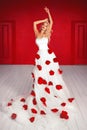 Young blonde girl in white dress with red roses Royalty Free Stock Photo